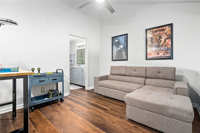 living room with ceiling fan, dark wood-type flooring, and vaulted ceiling