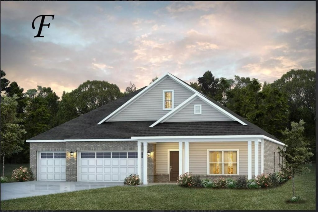 view of front facade with a garage and a yard