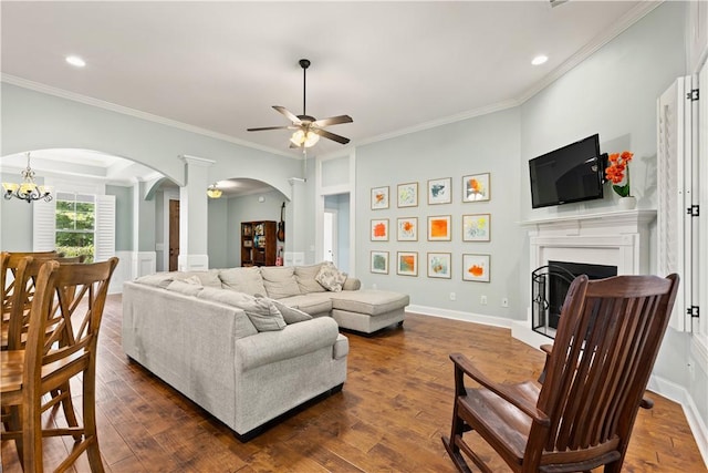 4112 Creekview Ct, Auburn, AL 36832 - living room featuring arched walkways, ceiling fan, a fireplace, crown molding, and dark wood-style flooring