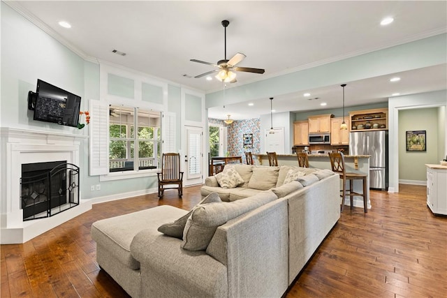4112 Creekview Ct, Auburn, AL 36832 - living room featuring ceiling fan, dark wood-style flooring, a fireplace with raised hearth, crown molding, and recessed lighting