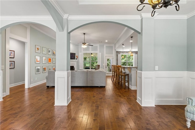 4112 Creekview Ct, Auburn, AL 36832 - living area featuring dark wood finished floors, a ceiling fan, a fireplace, crown molding, and arched walkways