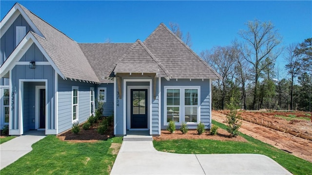 085 Bradley Ln, Auburn, AL 36830 - view of front facade with a shingled roof, board and batten siding, and a front lawn