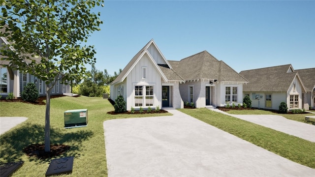 view of front of property with board and batten siding, driveway, and a front lawn