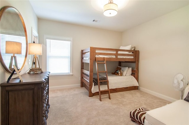 bedroom with light colored carpet