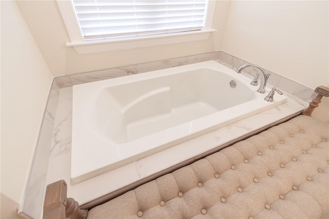 bathroom with a relaxing tiled tub