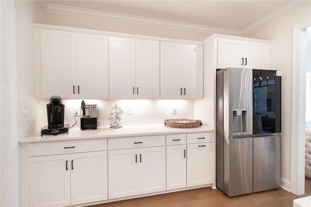 kitchen featuring white cabinetry, tasteful backsplash, stainless steel refrigerator with ice dispenser, crown molding, and light wood-type flooring