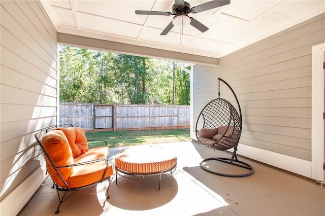 exterior space with ceiling fan, wood walls, and concrete floors