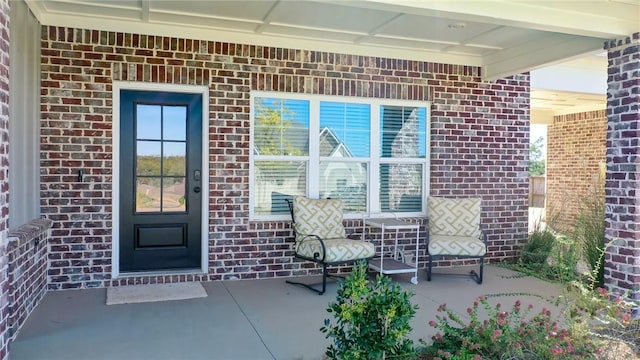 view of exterior entry with covered porch