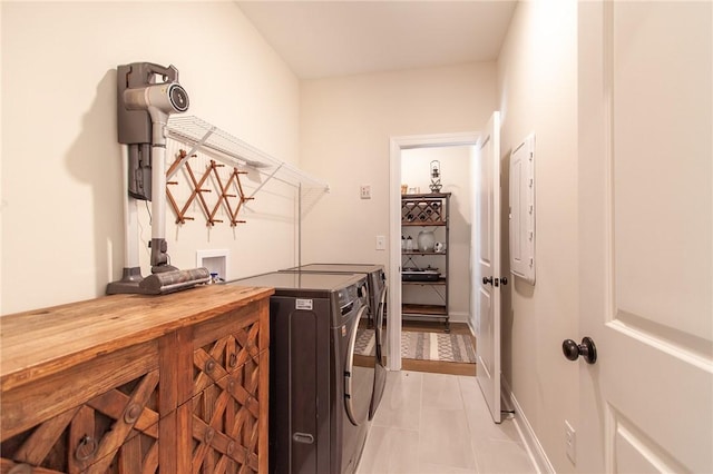 washroom with washer and dryer and light tile patterned floors