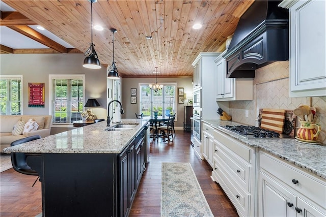1895 Talcott Ct, Auburn, AL 36830 - kitchen featuring stainless steel appliances, a chandelier, dark wood-style flooring, decorative backsplash, and premium range hood