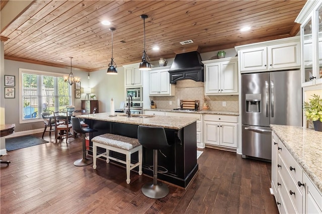 1895 Talcott Ct, Auburn, AL 36830 - kitchen featuring appliances with stainless steel finishes, custom range hood, a kitchen bar, crown molding, and white cabinetry