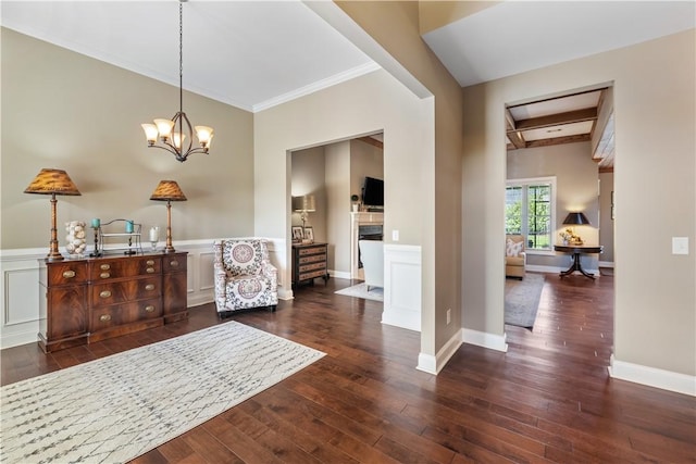 1895 Talcott Ct, Auburn, AL 36830 - foyer with a fireplace, wood-type flooring, ornamental molding, a chandelier, and a wainscoted wall