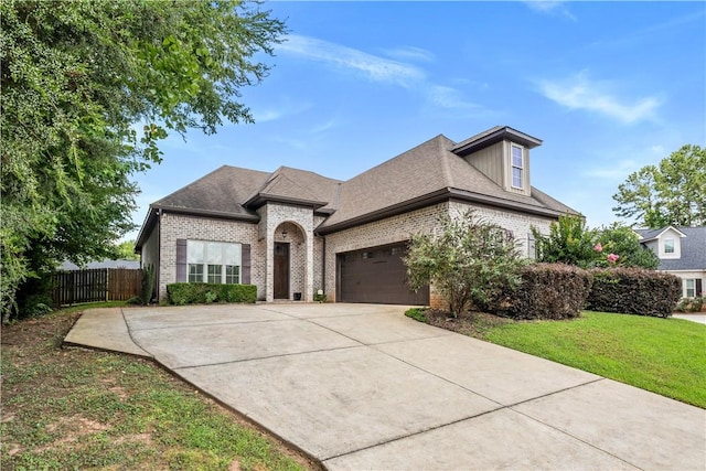 1895 Talcott Ct, Auburn, AL 36830 - french country home with brick siding, a garage, driveway, and a shingled roof