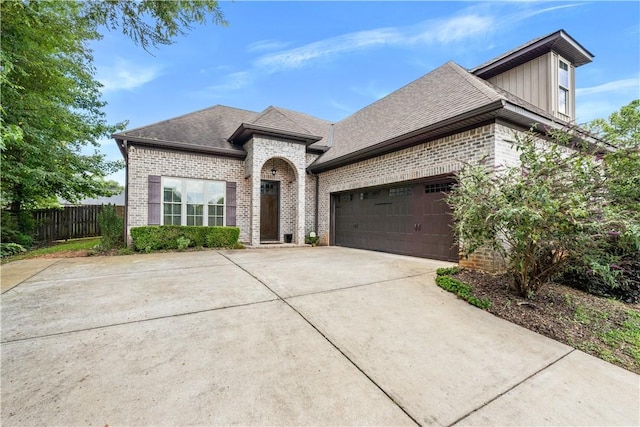 1895 Talcott Ct, Auburn, AL 36830 - french country home with brick siding, concrete driveway, a garage, and a shingled roof