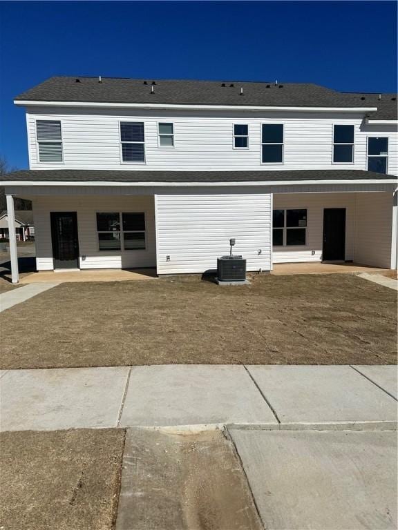 view of front of house with cooling unit and a patio area