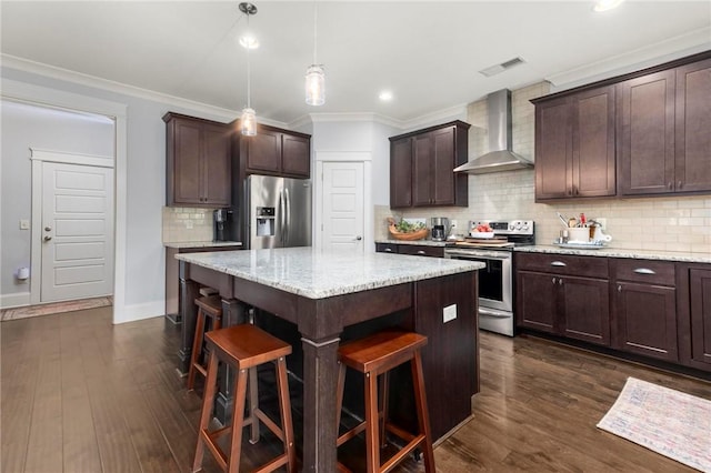 2217 Morgan Dr, Auburn, AL 36830 - kitchen with wall chimney range hood, stainless steel appliances, a center island, a kitchen bar, and dark brown cabinetry