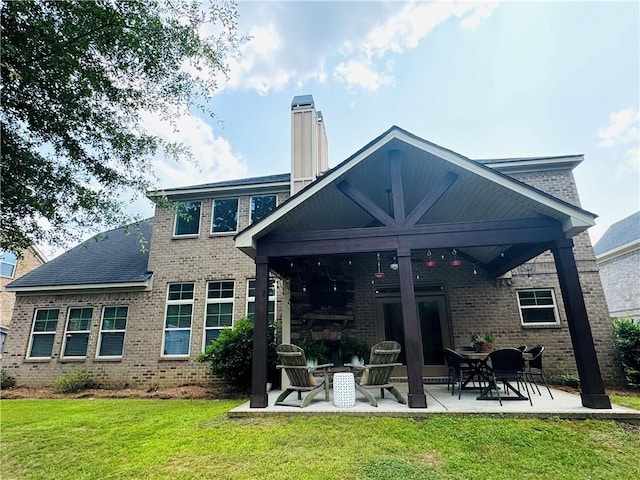 2217 Morgan Dr, Auburn, AL 36830 - rear view of property featuring a patio, a yard, brick siding, and a chimney