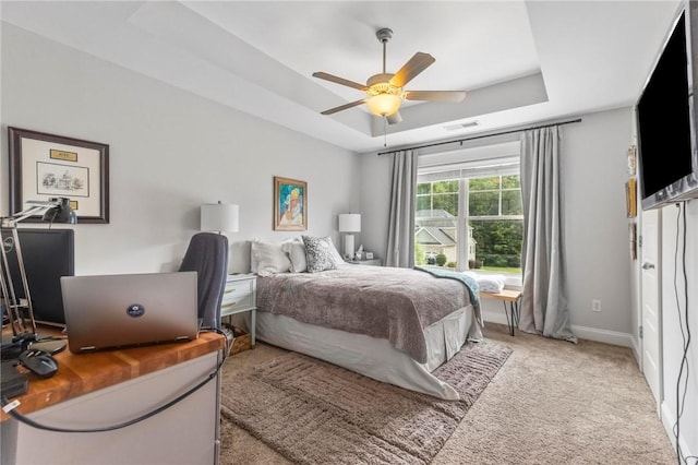 2217 Morgan Dr, Auburn, AL 36830 - carpeted bedroom featuring a raised ceiling, baseboards, and a ceiling fan