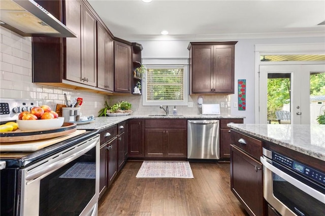 2217 Morgan Dr, Auburn, AL 36830 - kitchen with stainless steel appliances, under cabinet range hood, a sink, healthy amount of natural light, and crown molding