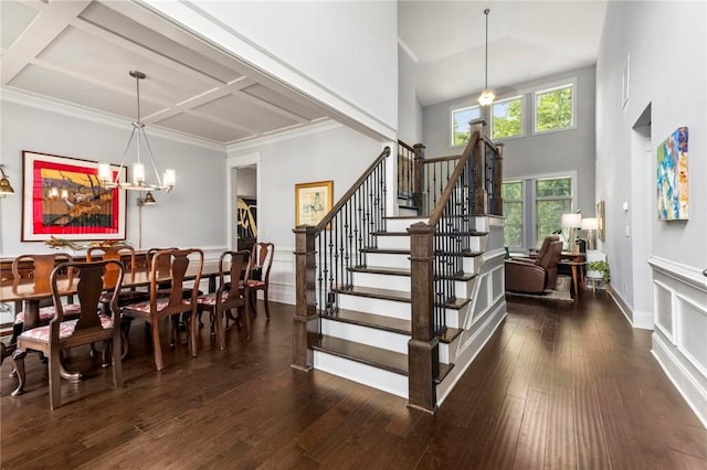 2217 Morgan Dr, Auburn, AL 36830 - dining room featuring a chandelier, hardwood / wood-style floors, stairway, a towering ceiling, and coffered ceiling