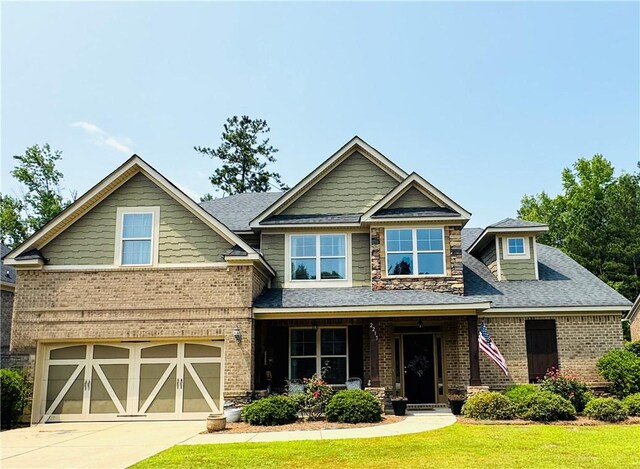 2217 Morgan Dr, Auburn, AL 36830 - craftsman-style home with brick siding, a front lawn, an attached garage, and driveway