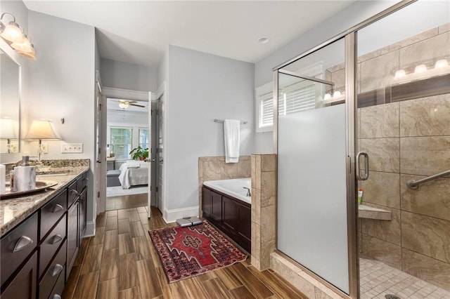 2217 Morgan Dr, Auburn, AL 36830 - bathroom with ensuite bath, double vanity, a bath, a shower stall, and wood tiled floors