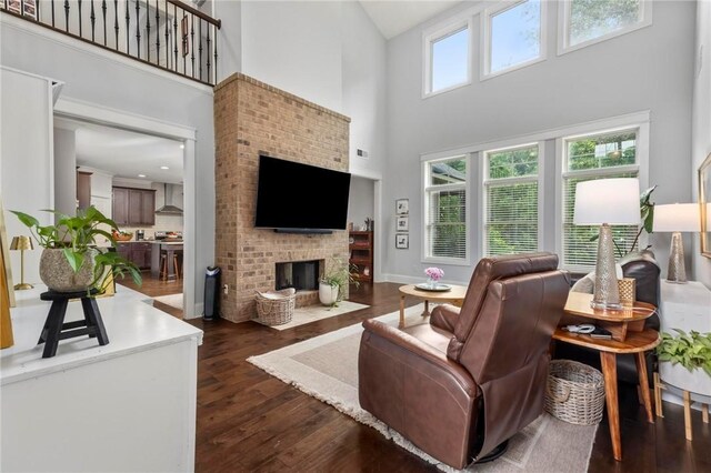 2217 Morgan Dr, Auburn, AL 36830 - living room with a towering ceiling, a fireplace, dark wood finished floors, and baseboards