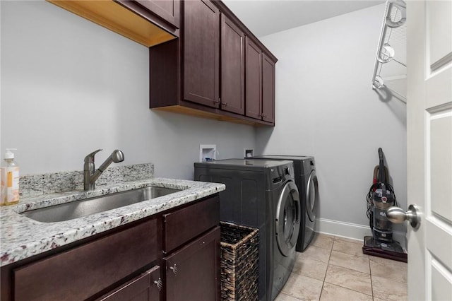 2217 Morgan Dr, Auburn, AL 36830 - laundry room with cabinet space, washing machine and dryer, baseboards, and light tile patterned floors