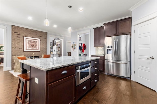2217 Morgan Dr, Auburn, AL 36830 - kitchen featuring stainless steel appliances, ornamental molding, dark wood-style flooring, a breakfast bar area, and light stone counters