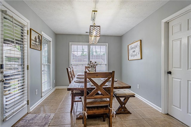 205 Summerbrooke Loop, Phenix City, AL 36870 - dining space featuring light tile patterned floors, a textured ceiling, and baseboards