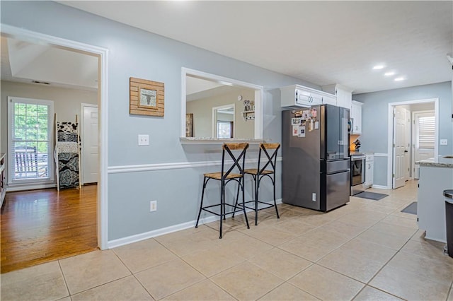205 Summerbrooke Loop, Phenix City, AL 36870 - kitchen with appliances with stainless steel finishes, light tile patterned floors, white cabinets, baseboards, and recessed lighting