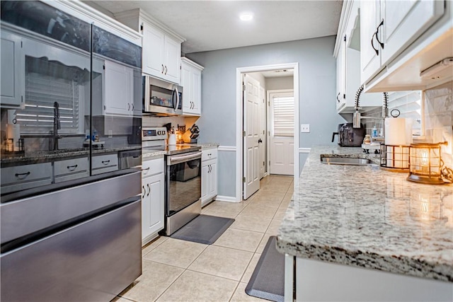 205 Summerbrooke Loop, Phenix City, AL 36870 - kitchen featuring appliances with stainless steel finishes, tasteful backsplash, a sink, light tile patterned floors, and recessed lighting