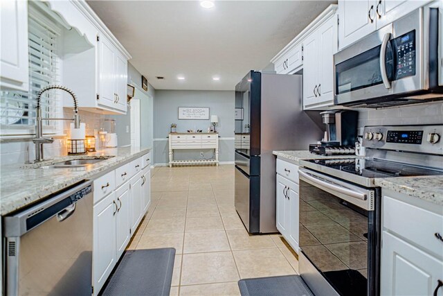 205 Summerbrooke Loop, Phenix City, AL 36870 - kitchen featuring stainless steel appliances, a sink, white cabinets, tasteful backsplash, and recessed lighting