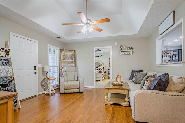 205 Summerbrooke Loop, Phenix City, AL 36870 - living room with a raised ceiling, light wood-style flooring, ceiling fan, and baseboards