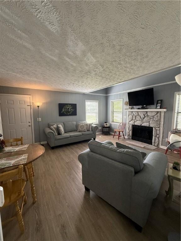 living area featuring a textured ceiling, wood finished floors, and a premium fireplace