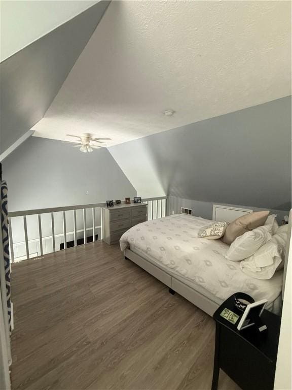 bedroom featuring a ceiling fan, vaulted ceiling, and wood finished floors