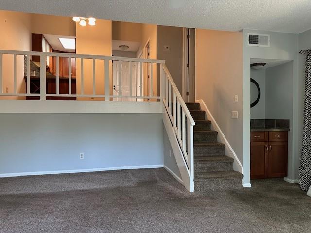 371 E Thach Ave Unit 4, Auburn, AL 36830 - stairs with carpet floors, a textured ceiling, and baseboards