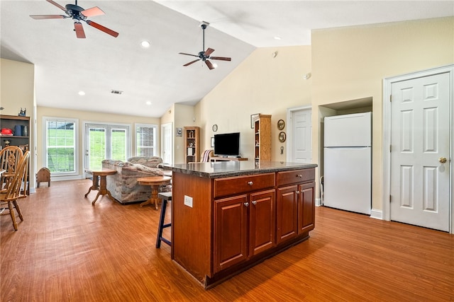 802 W Longleaf Dr Unit 71, Auburn, AL 36832 - kitchen featuring freestanding refrigerator, open floor plan, ceiling fan, wood finished floors, and high vaulted ceiling