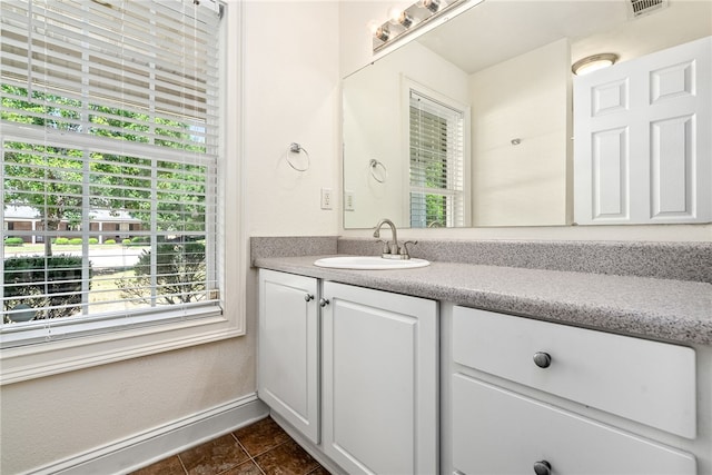 802 W Longleaf Dr Unit 71, Auburn, AL 36832 - bathroom featuring healthy amount of natural light, vanity, tile patterned flooring, and baseboards