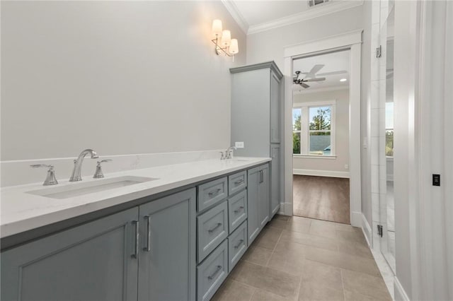 bathroom featuring a sink, tile patterned floors, ornamental molding, and ceiling fan