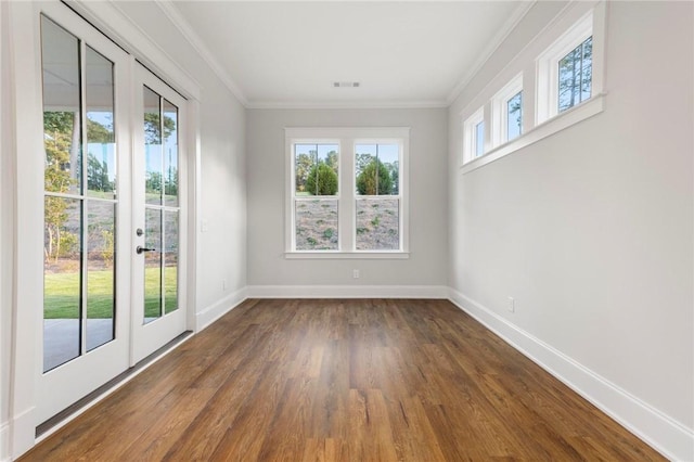 interior space featuring crown molding, dark wood-style flooring, french doors, baseboards, and visible vents