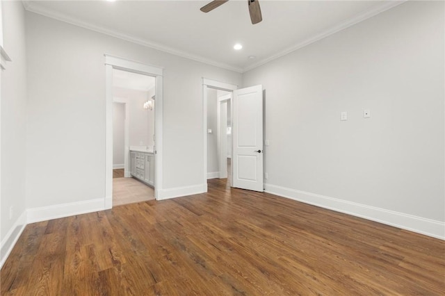unfurnished bedroom featuring crown molding, wood finished floors, baseboards, connected bathroom, and recessed lighting