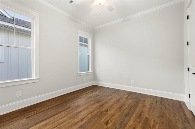 spare room with a ceiling fan, visible vents, crown molding, dark wood finished floors, and baseboards