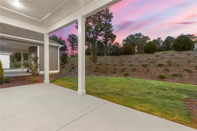 yard at dusk with a patio area