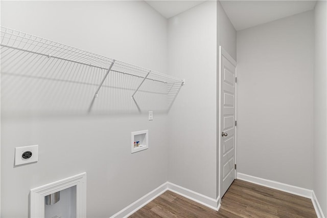 laundry room featuring hookup for a washing machine, laundry area, dark wood-type flooring, baseboards, and electric dryer hookup