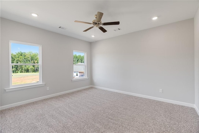 empty room with carpet, baseboards, visible vents, and recessed lighting