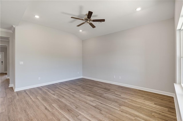 empty room featuring baseboards, wood finished floors, and recessed lighting