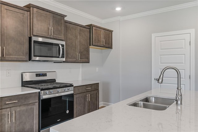 kitchen with appliances with stainless steel finishes, a sink, crown molding, dark brown cabinets, and backsplash