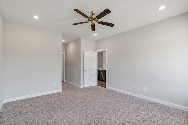 carpeted spare room with a ceiling fan, recessed lighting, and baseboards