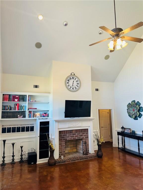 living room with a brick fireplace, high vaulted ceiling, and ceiling fan